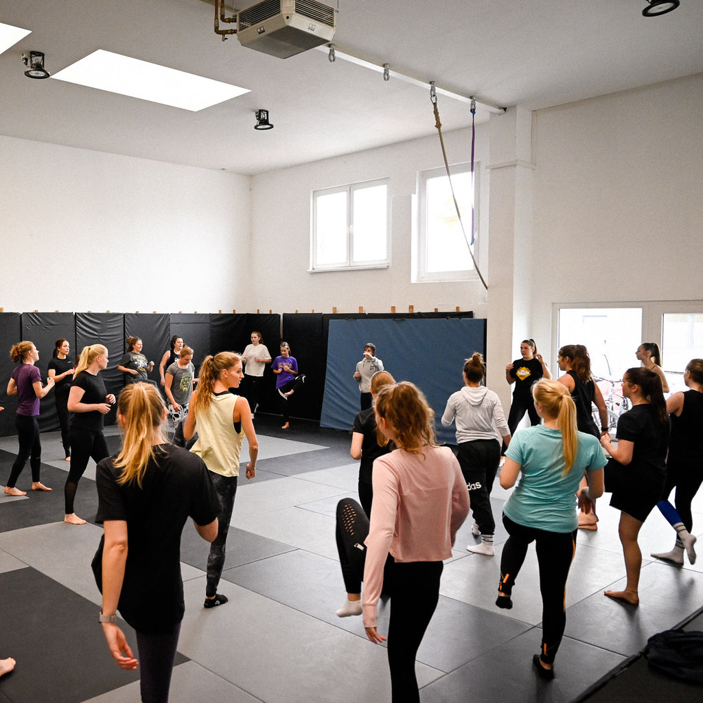 Eine Gruppe Frauen beim Aufwärmen für den kostenlosen Selbstvertedigungsworkshop der Kampfsportmarke Chinkilla. A group of women during the warm up for the free self-defense workshop by the martial arts brand Chinkilla.